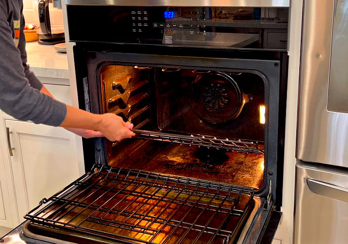 Image of a really dirty oven about to be cleaned.