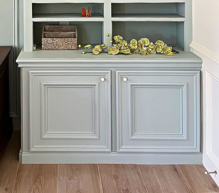 Image of a built in cabinet with baseboard along bottom.