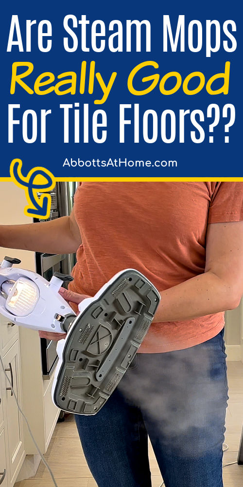 Image of someone holding a steam mop for tiles for a post answering "is a steam mop best for tile floors". are steam mops good for tile floors?