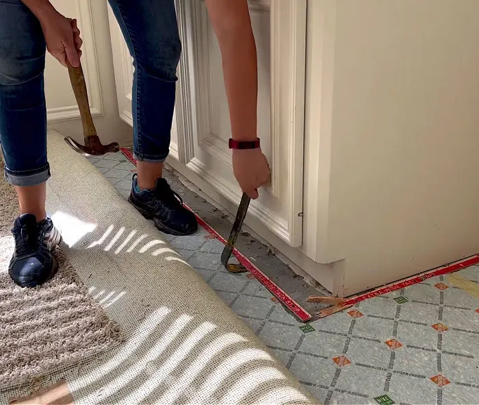 Image of someone removing carpet.