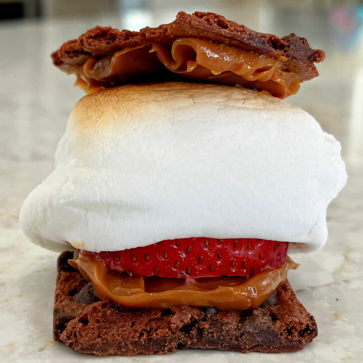 Caramel Smores made with brownie brittle, strawberry, and roasted marshmallow.