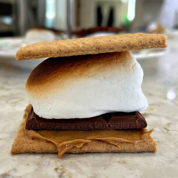 Smores variation with graham cracker, peanut butter, Hershey's Bar and oven roasted marshmallow.