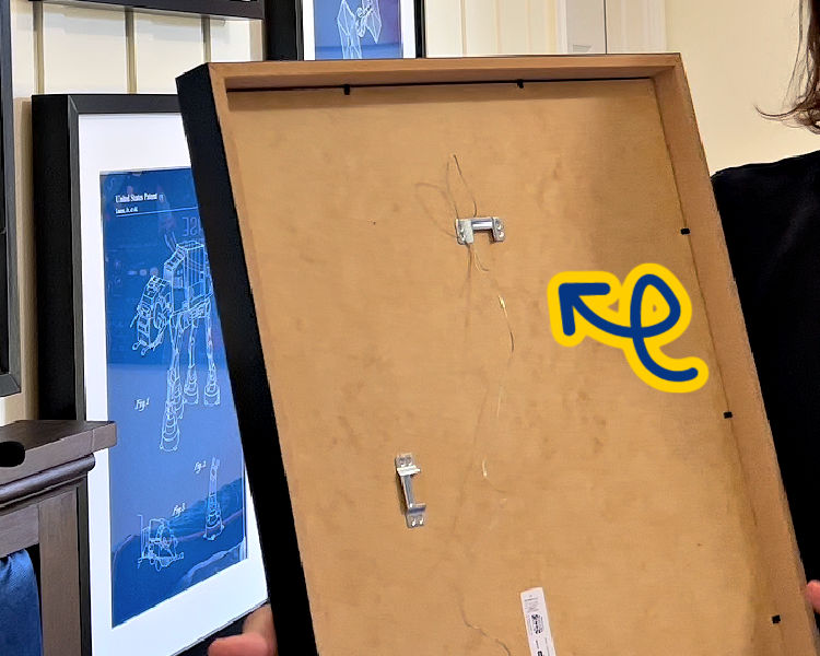 Image shows picture hanging wire on the IKEA picture frame sawtooth hanger.