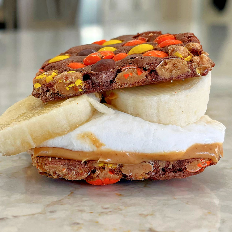 Different Smores Alternative using Reese's Pieces Brownie Brittle, Peanut Butter, Oven Roasted Marshmallow, and banana.