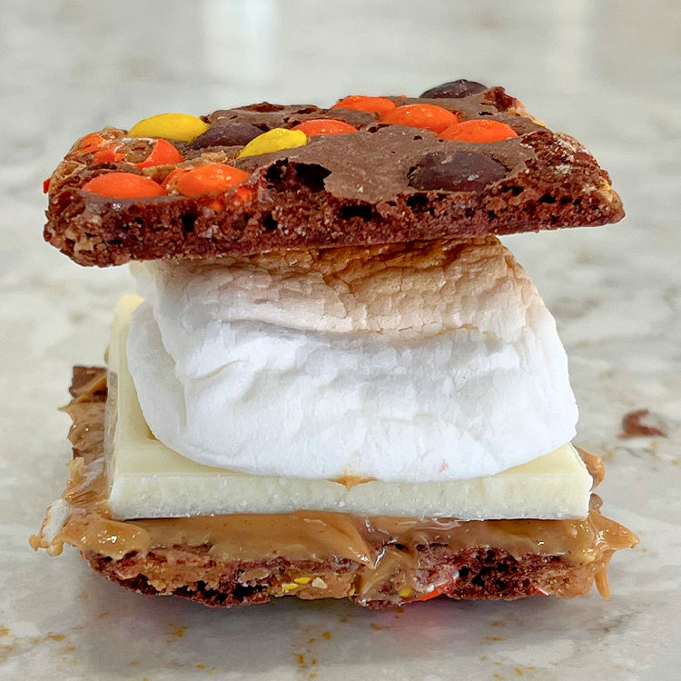 Make Smore's at home with Reese's Pieces Brownie Brittle, Peanut Butter, White Chocolate, and oven roasted marshmallow.