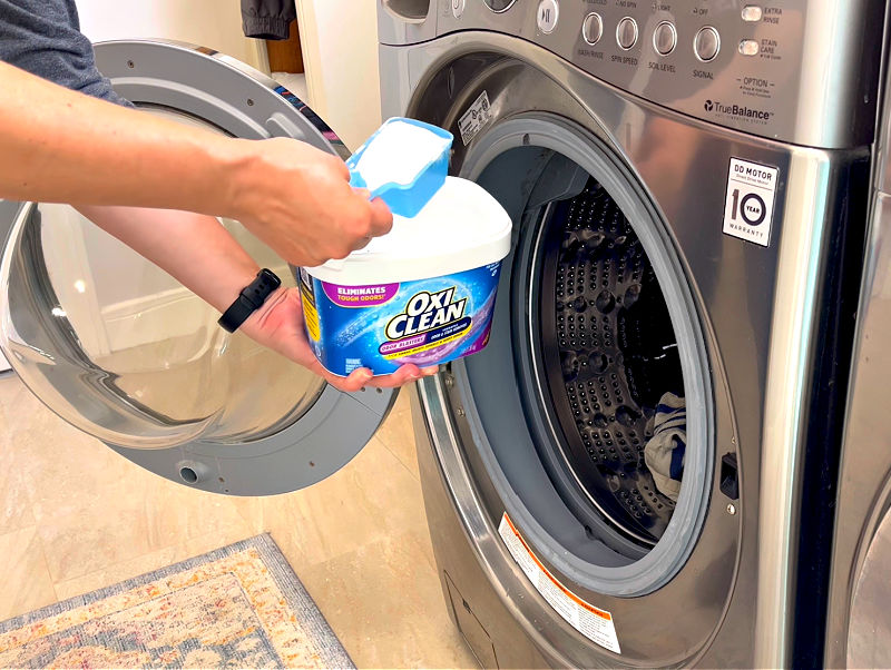 Using OxiClean Odor Blasters to remove bad smells from laundry.