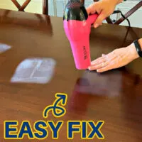 Image shows how to remove a heat mark on wood with a blow dryer. For a post about ways to get rid of heat stains on wood tables.