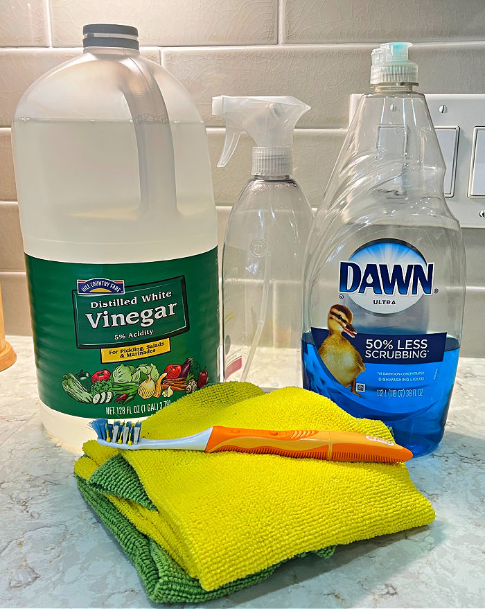 Examples of cleaners that don't damage the finish on kitchen cabinets for a post with 3 ways to clean white kitchen cabinets.