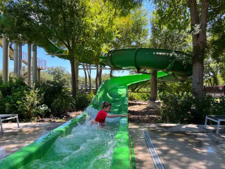 Image of a shaded resort water park in Texas for a post with 50 pros and cons about moving to Houston Texas.