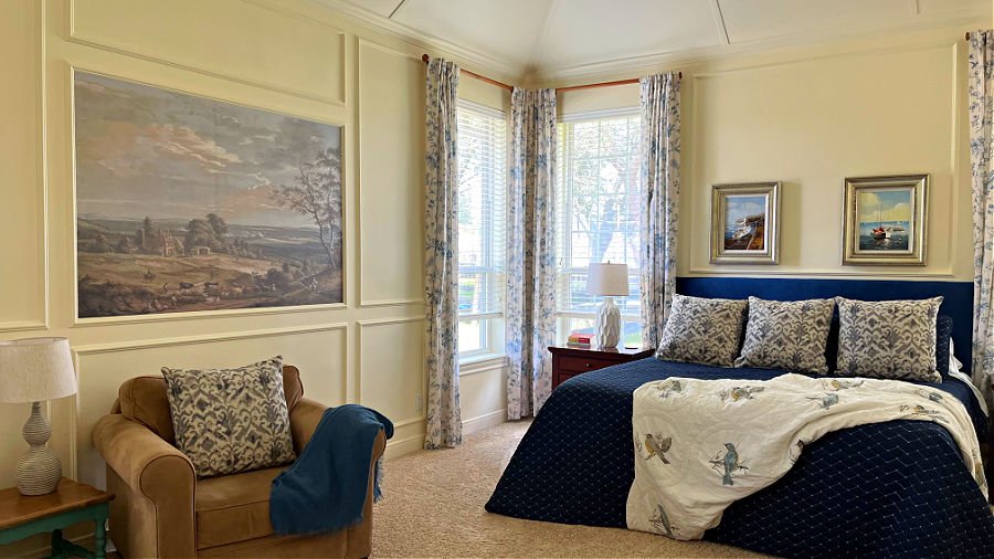 Before and after room makeover on a master bedroom with white trim walls and a vaulted ceiling.