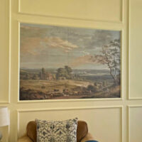 Image of a Framed Wallpaper Mural DIY for a post about how to frame a wallpaper mural with picture frame trim on a wall.
