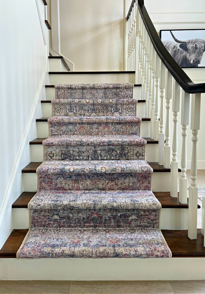 Image of 3 area rugs used as a rug runner on stairs.