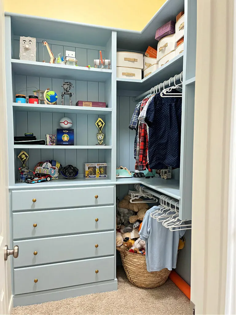 Image of an organized closet with built ins for a post with 11 ways to make a dark closet feel brighter or how to brighten a closet.