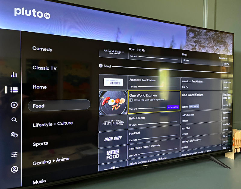 Image of a TV showing the guide to Pluto TV for a post about how to cut cable and still watch TV for free.