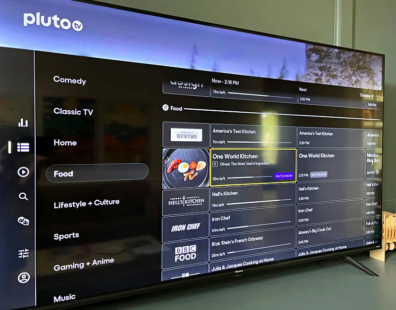 Image of a TV showing the guide to Pluto TV for a post about how to cut cable and still watch TV for free.