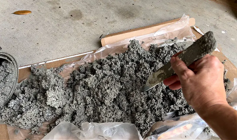 Image of dried out paint using kitty litter for a post about how to dry out paint with kitty litter.