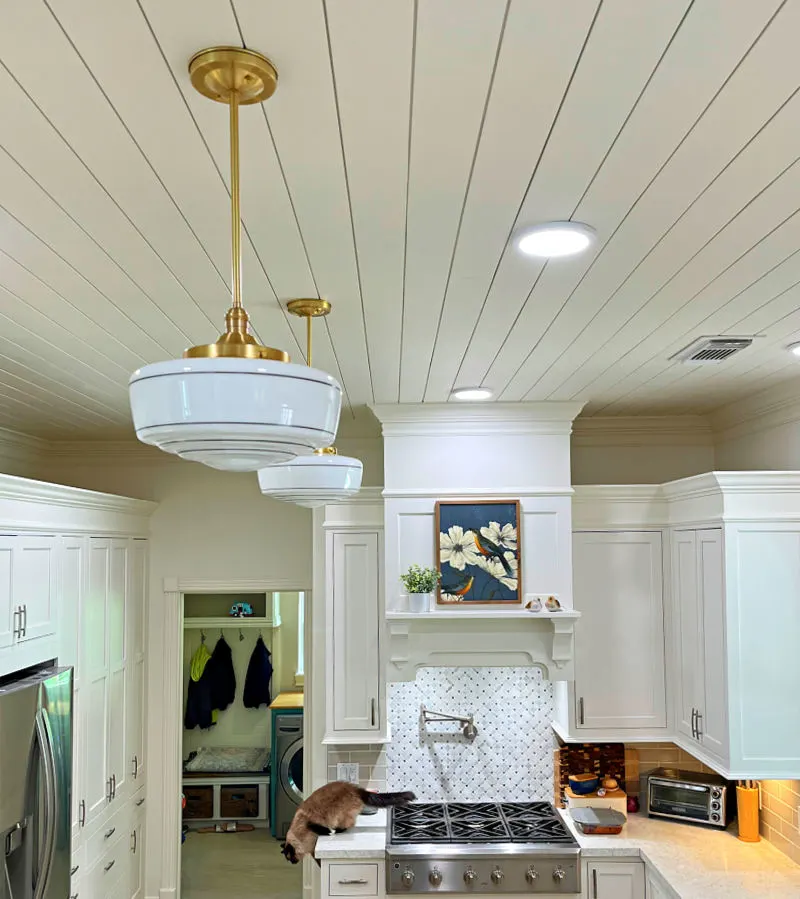 Olde Brick Lighting Milk Glass Vintage Style Pendant lights over an island in a kitchen.