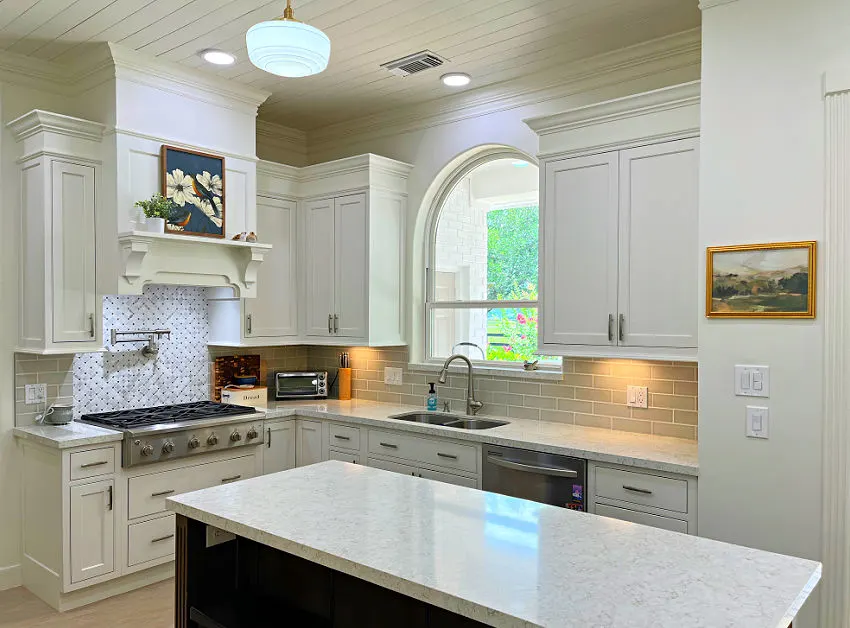 Shiplap ceiling over a traditional white kitchen with lots of finish carpentry. crown molding cabinets, and trim.