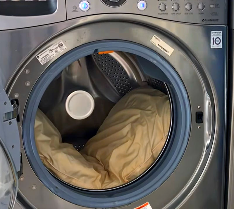 Using a washing machine to wash pillows.