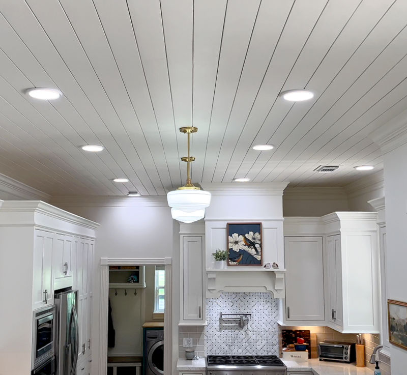 Covering ceiling texture with shiplap in a white traditional kitchen.