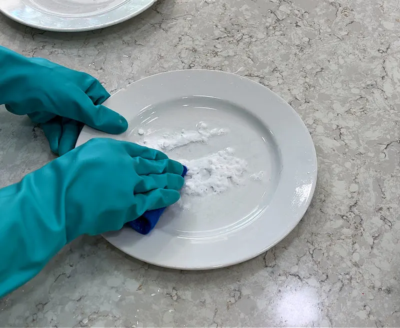 Vinegar and baking soda on a plate with silverware scratches.