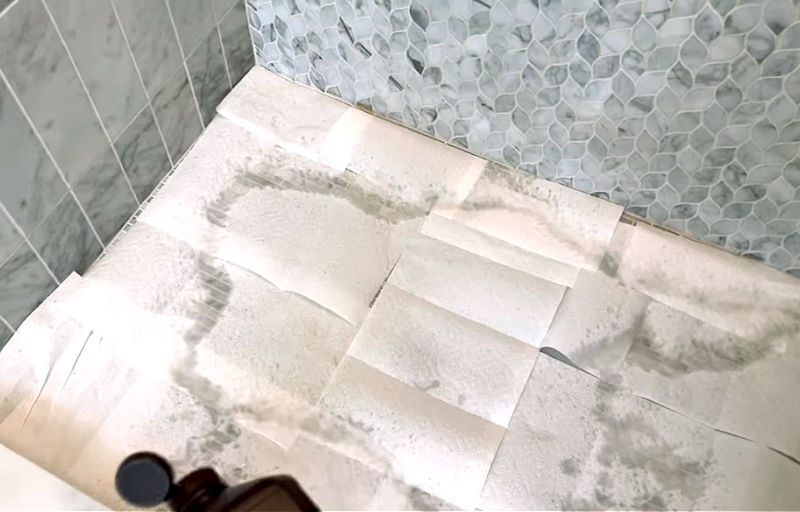 Using hydrogen peroxide to whiten marble shower grout.