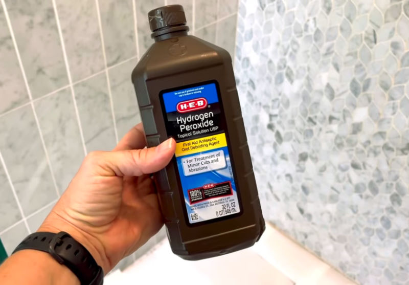 Using hydrogen peroxide to whiten marble shower grout.