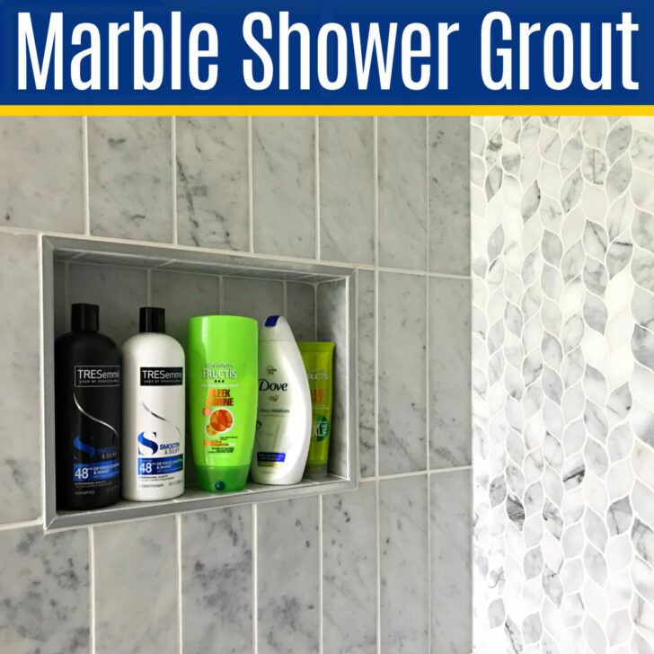 Image of a marble shower with white grout for a post about how to clean marble shower grout and tile.