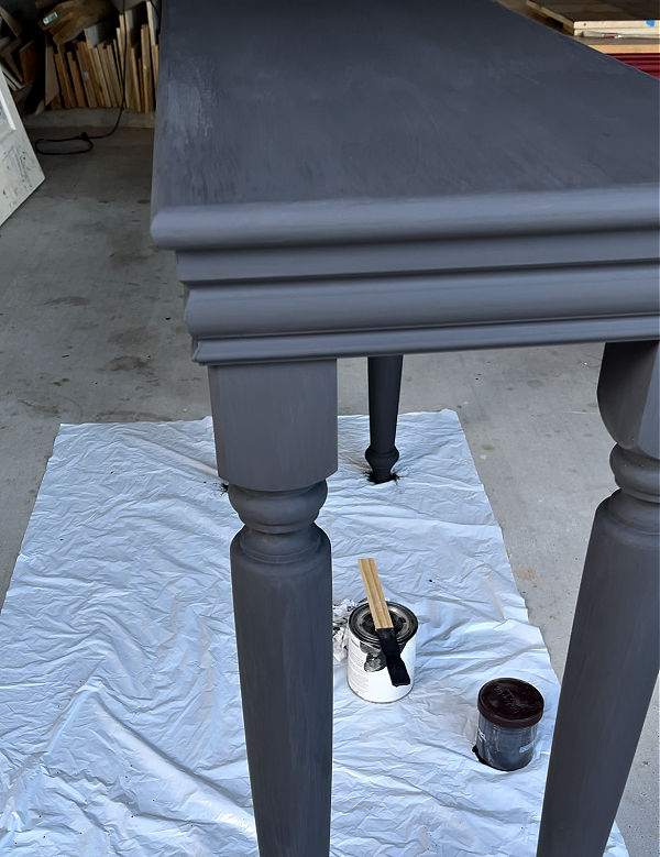 Furniture with two coats of a black paint wash.